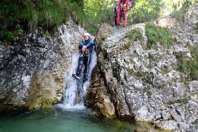 Canyoning in Bled - Entering the canyon: slides, pool jumps, and rope-assisted waterfall time